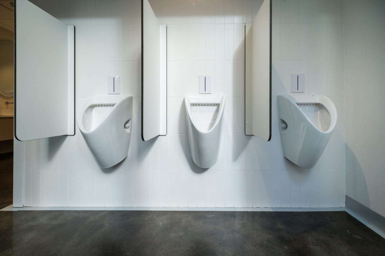 The interior design of TriQube's bathrooms embraces a serene, minimalist aesthetic, with rounded shapes and a soothing colour palette creating a calming atmosphere. Chic urinals add a touch of distinction, offering both urban flair and unique appeal, while Access grab bars and Meridian toilets ensure accessibility and comfort. Roca products were carefully selected to enhance both the functionality and innovative spirit of the space, contributing to its high standards of quality and design.9