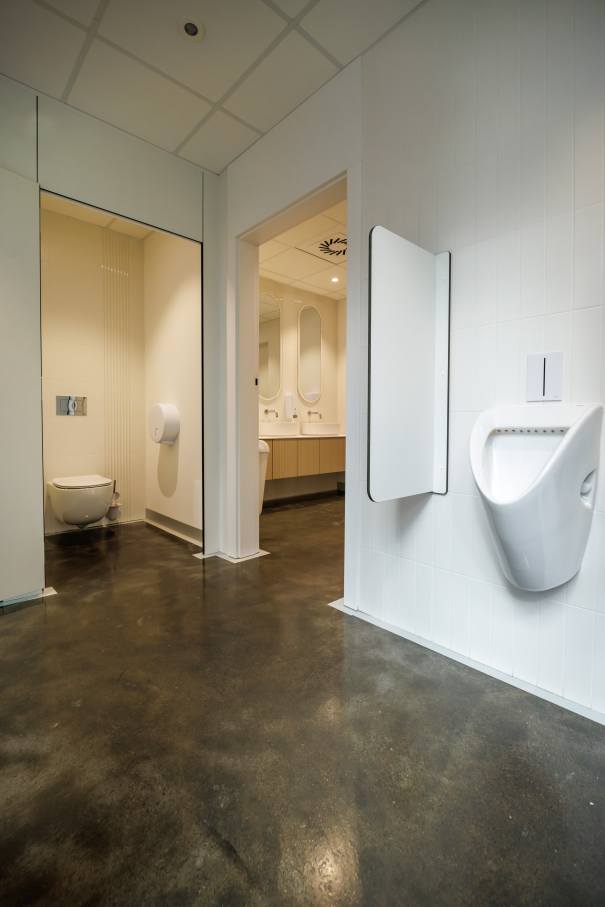 The interior design of TriQube's bathrooms embraces a serene, minimalist aesthetic, with rounded shapes and a soothing colour palette creating a calming atmosphere. Chic urinals add a touch of distinction, offering both urban flair and unique appeal, while Access grab bars and Meridian toilets ensure accessibility and comfort. Roca products were carefully selected to enhance both the functionality and innovative spirit of the space, contributing to its high standards of quality and design.7